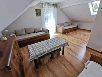 a living room with a couch and a table at Agrostrzecha in Ryczów