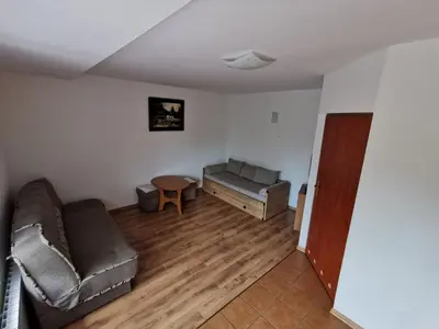 a living room with a couch and a table at Agrostrzecha in Ryczów