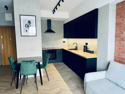 a kitchen with a table and chairs and a couch at Apartament Róża 1 Zator - 2 km od Energylandii in Zator