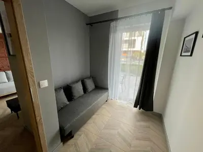 a living room with a couch and a window at Apartament Róża 1 Zator - 2 km od Energylandii in Zator