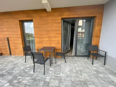 a group of chairs and a table on a patio at Apartament Róża 1 Zator - 2 km od Energylandii in Zator