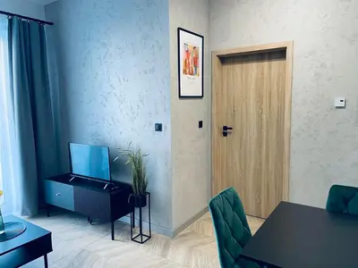 a room with a door and a table and a table and chairs at Apartament Róża 1 Zator - 2 km od Energylandii in Zator