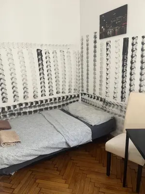 a room with a bed and a chair in it at PIRANIA in Kraków