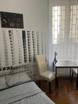 a bedroom with a bed and a desk and a table at PIRANIA in Kraków