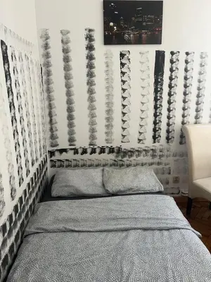 a bedroom with a bed and a wall with patterns at PIRANIA in Kraków