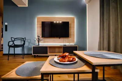 a living room with a table with a plate of food at Apartament No 61 Blue Holiday Home Zator in Zator