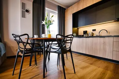 a dining room with a table and chairs in a kitchen at Apartament No 61 Blue Holiday Home Zator in Zator