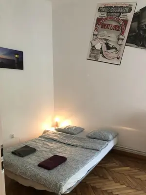 a bed in a room with a poster on the wall at Wawel in Kraków