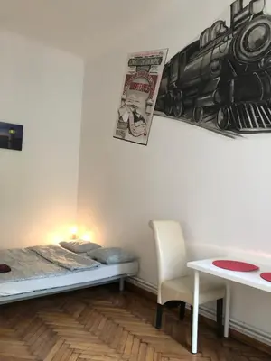 a bedroom with a bed and a table and a chair at Wawel in Kraków