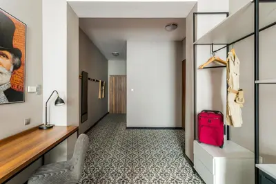 a hallway with a room with a red suitcase at No.23 Premium Aparthotel in Kraków