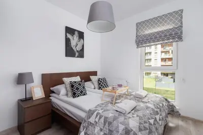 a bedroom with a bed and a window at Krowodrza Apartment Premium with Balcony by Renters Prestige in Kraków