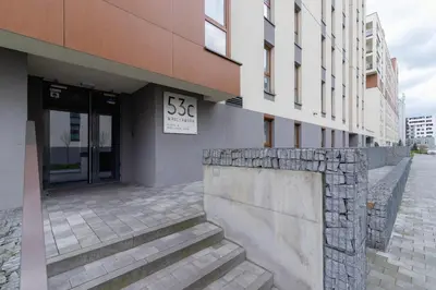 a building with a sign on the side of it at Krowodrza Apartment Premium with Balcony by Renters Prestige in Kraków