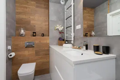 a bathroom with a white sink and a toilet at Krowodrza Apartment Premium with Balcony by Renters Prestige in Kraków