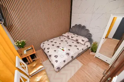 a small bedroom with a bed and a mirror at REZYDENCJA ZATOR in Zator
