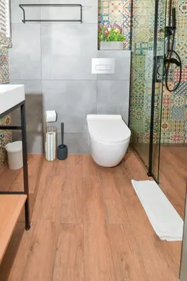a bathroom with a white toilet and a shower at REZYDENCJA ZATOR in Zator
