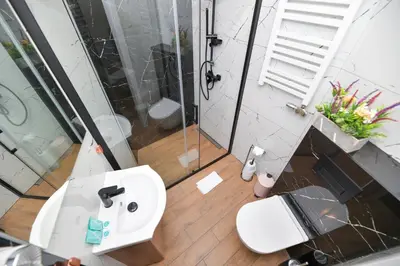 a bathroom with a toilet and a sink and a shower at REZYDENCJA ZATOR in Zator