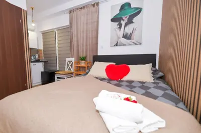 a bedroom with a bed with a red heart on it at REZYDENCJA ZATOR in Zator