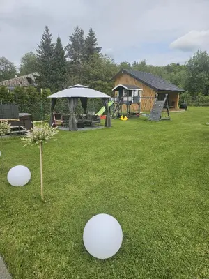 a yard with three white frisbees in the grass at Domek Komfort w górach przy Parku in Rabka