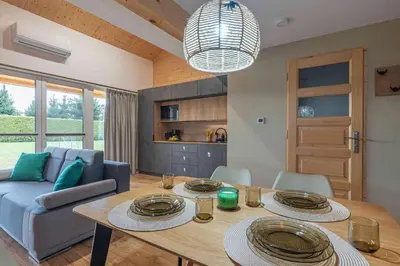 a living room with a table and a blue couch at Domek Komfort w górach przy Parku in Rabka