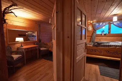 a room with a bed and a desk in a cabin at Górna Chata Mountains Chalet in Ochotnica Górna
