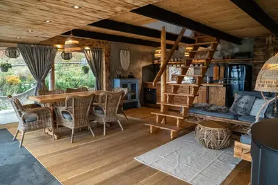 a living room with a wooden table and chairs at Górna Chata Mountains Chalet in Ochotnica Górna