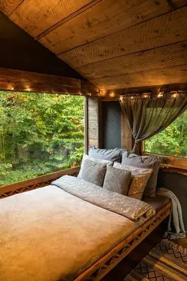 a large bed in a room with a window at Górna Chata Mountains Chalet in Ochotnica Górna