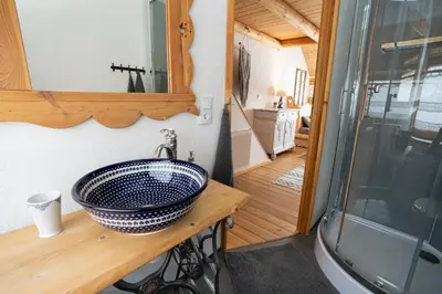 a bathroom with a sink and a mirror on a counter at Górna Chata Mountains Chalet in Ochotnica Górna