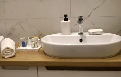 a white sink on a wooden counter in a bathroom at Cozy Apartment In Zator With Wifi in Zator