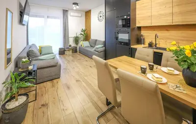 a kitchen and a living room with a table and chairs at Cozy Apartment In Zator With Wifi in Zator