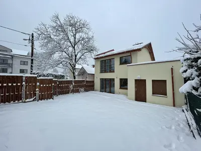 a driveway covered in snow in front of a house at Włodarska 11 in Kraków