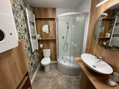 a bathroom with a shower and a toilet and a sink at Włodarska 11 in Kraków