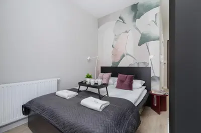 a bedroom with a bed with two pillows on it at Casa Feliz Zabłocie Studio for 4 Guests Cracow by Noclegi Renters in Kraków