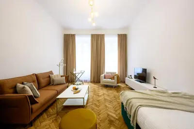 a living room with a couch and a bed at Native Apartments Dietla 71 in Kraków