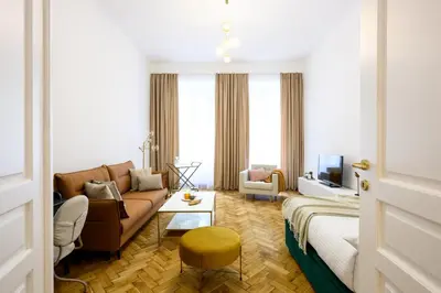 a living room with a couch and a table at Native Apartments Dietla 71 in Kraków