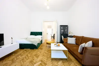 a living room with a couch and a bed at Native Apartments Dietla 71 in Kraków