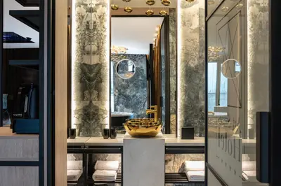 a dressing room with a mirror and a sink at Art Suites Luxury Hotel in Kraków