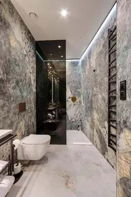 a bathroom with a white toilet and a sink at Art Suites Luxury Hotel in Kraków