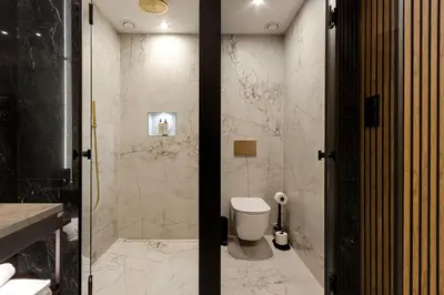 a bathroom with a shower with a toilet in it at Art Suites Luxury Hotel in Kraków