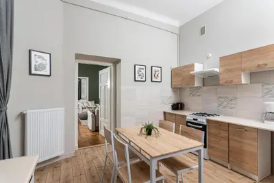 a kitchen with a table and chairs in a room at Przestronny Apartament w Centrum Krakowa - 12 osób - by Upstairs in Kraków
