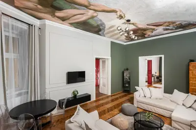 a living room with a ceiling with a painting at Przestronny Apartament w Centrum Krakowa - 12 osób - by Upstairs in Kraków