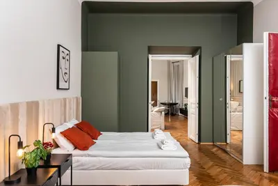 a bedroom with a bed and a living room at Przestronny Apartament w Centrum Krakowa - 12 osób - by Upstairs in Kraków