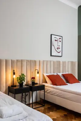 a bedroom with two beds and two tables with plants at Przestronny Apartament w Centrum Krakowa - 12 osób - by Upstairs in Kraków