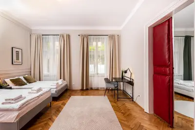 a bedroom with two beds and a desk in it at Przestronny Apartament w Centrum Krakowa - 12 osób - by Upstairs in Kraków