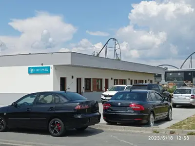 a parking lot with cars parked in front of a building at Loft Park Zator, lokalizacja przy wej Parku in Zator