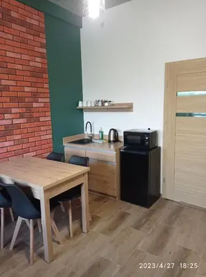 a kitchen with a table and a sink and a microwave at Loft Park Zator, lokalizacja przy wej Parku in Zator