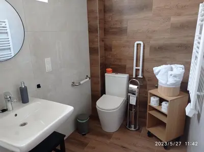 a bathroom with a white toilet and a sink at Loft Park Zator, lokalizacja przy wej Parku in Zator