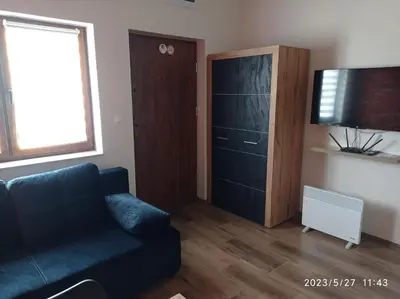 a living room with a couch and a cabinet at Loft Park Zator, lokalizacja przy wej Parku in Zator