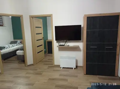 a bedroom with a bed and a dresser with a television at Loft Park Zator, lokalizacja przy wej Parku in Zator