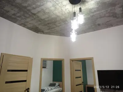 a room with a coffered ceiling and two doors at Loft Park Zator, lokalizacja przy wej Parku in Zator