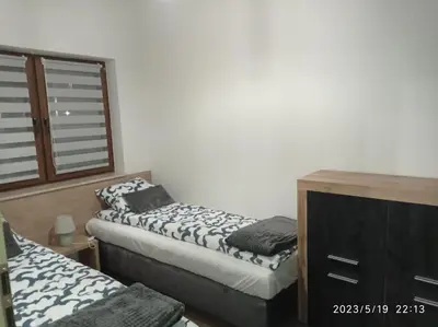 a bedroom with two twin beds and a dresser at Loft Park Zator, lokalizacja przy wej Parku in Zator